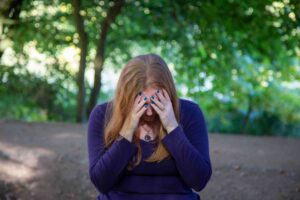 Worry sarah with her head in her hands when she's overthinking or worrying and feeling anxious